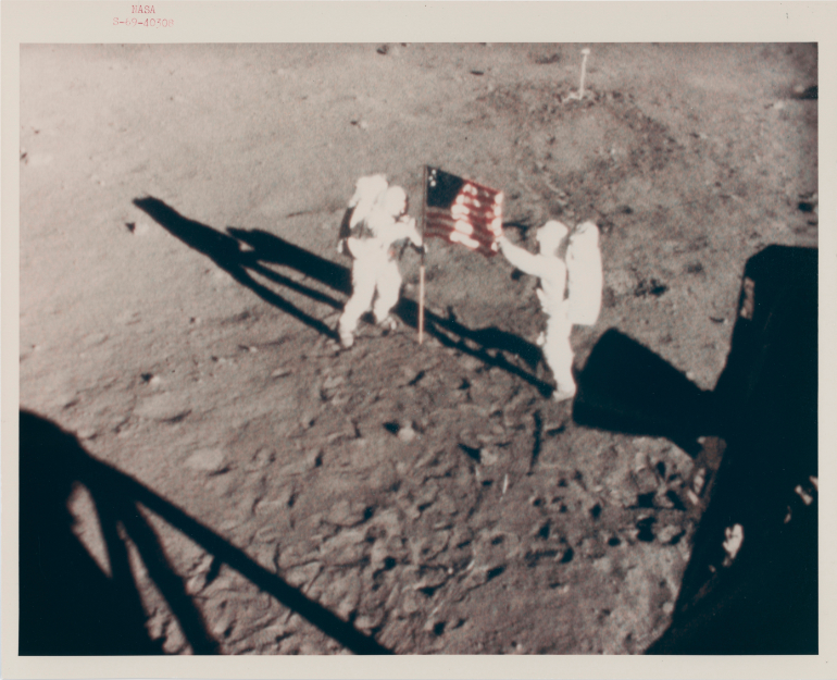 The astronauts planting the first US flag on the lunar surface